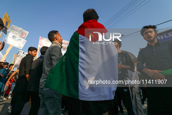 A Kashmiri Shia Muslim man is displaying a Palestinian flag during a procession on the 8th of Muharram in Srinagar, Indian Administered Kash...