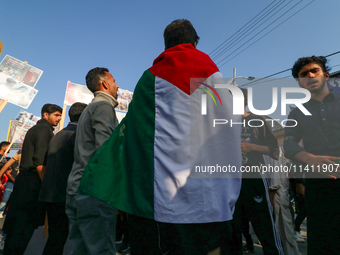 A Kashmiri Shia Muslim man is displaying a Palestinian flag during a procession on the 8th of Muharram in Srinagar, Indian Administered Kash...