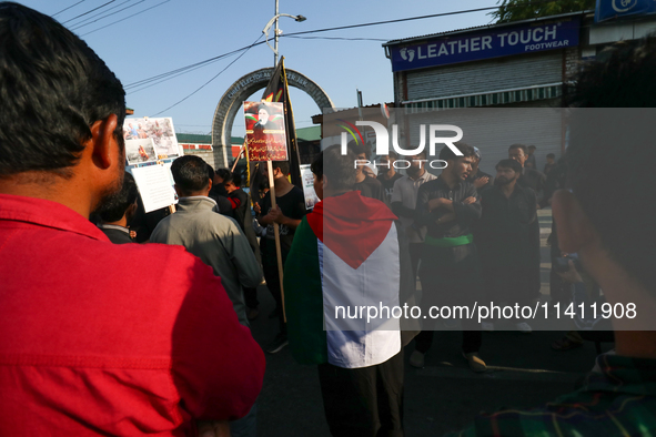 A Kashmiri Shia Muslim man is displaying a Palestinian flag during a procession on the 8th of Muharram in Srinagar, Indian Administered Kash...