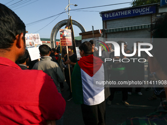 A Kashmiri Shia Muslim man is displaying a Palestinian flag during a procession on the 8th of Muharram in Srinagar, Indian Administered Kash...