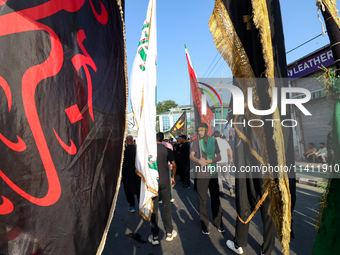 Kashmiri Shia Muslims are displaying flags during a procession on the 8th of Muharram in Srinagar, Indian Administered Kashmir, on July 15,...