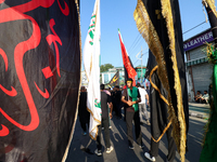 Kashmiri Shia Muslims are displaying flags during a procession on the 8th of Muharram in Srinagar, Indian Administered Kashmir, on July 15,...