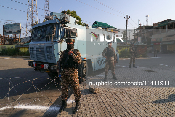 Indian paramilitary troopers are standing alert during a procession on the 8th of Muharram in Srinagar, Indian Administered Kashmir, on July...