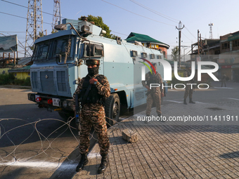 Indian paramilitary troopers are standing alert during a procession on the 8th of Muharram in Srinagar, Indian Administered Kashmir, on July...