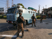 Indian paramilitary troopers are standing alert during a procession on the 8th of Muharram in Srinagar, Indian Administered Kashmir, on July...