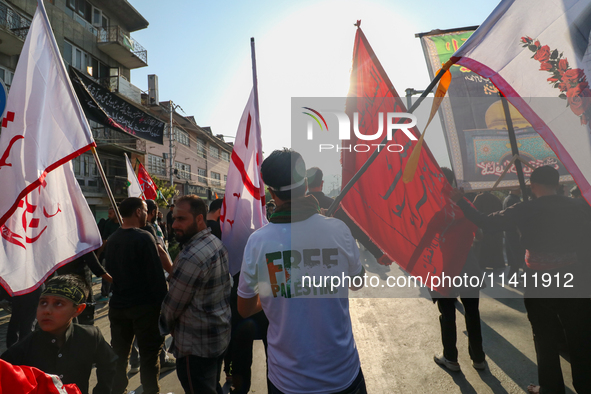 Kashmiri Shia Muslims are displaying flags during a procession on the 8th of Muharram in Srinagar, Indian Administered Kashmir, on July 15,...