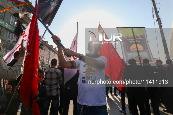 Kashmiri Shia Muslims are displaying flags during a procession on the 8th of Muharram in Srinagar, Indian Administered Kashmir, on July 15,...