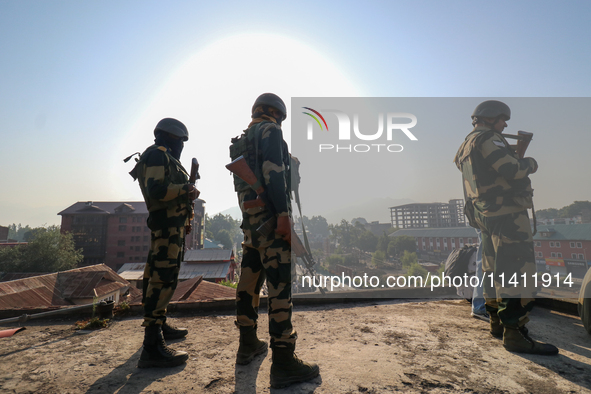 Indian paramilitary troopers are standing alert during a procession on the 8th of Muharram in Srinagar, Indian Administered Kashmir, on July...