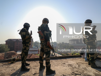 Indian paramilitary troopers are standing alert during a procession on the 8th of Muharram in Srinagar, Indian Administered Kashmir, on July...