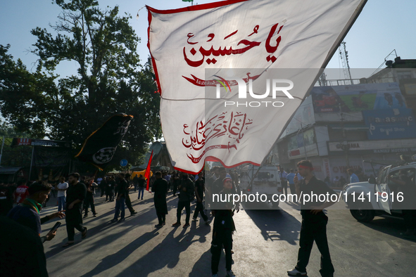 Kashmiri Shia Muslims are displaying flags during a procession on the 8th of Muharram in Srinagar, Indian Administered Kashmir, on July 15,...