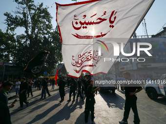 Kashmiri Shia Muslims are displaying flags during a procession on the 8th of Muharram in Srinagar, Indian Administered Kashmir, on July 15,...