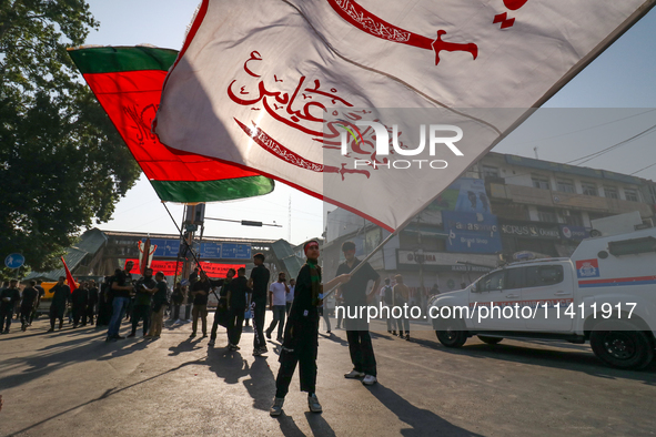 Kashmiri Shia Muslims are displaying flags during a procession on the 8th of Muharram in Srinagar, Indian Administered Kashmir, on July 15,...