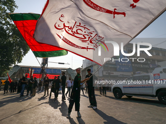 Kashmiri Shia Muslims are displaying flags during a procession on the 8th of Muharram in Srinagar, Indian Administered Kashmir, on July 15,...