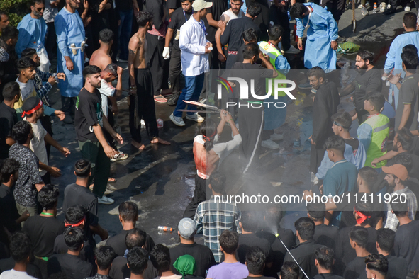 A Kashmiri Shia Muslim is flagellating himself during a procession on the 8th of Muharram in Srinagar, Indian Administered Kashmir, on July...