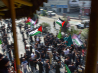 A Kashmiri Shia Muslim man is displaying a Palestinian flag during a procession on the 8th of Muharram in Srinagar, Indian Administered Kash...