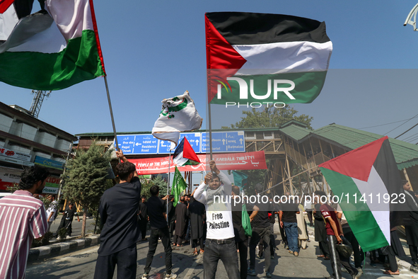 Kashmiri Shia Muslims are displaying Palestinian flags during a procession on the 8th of Muharram in Srinagar, Indian Administered Kashmir,...