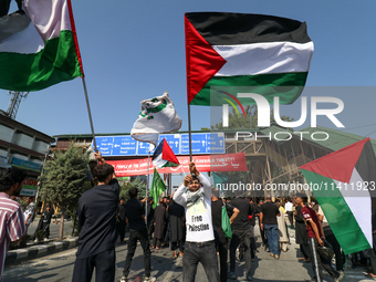 Kashmiri Shia Muslims are displaying Palestinian flags during a procession on the 8th of Muharram in Srinagar, Indian Administered Kashmir,...