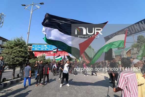 Kashmiri Shia Muslims are displaying Palestinian flags during a procession on the 8th of Muharram in Srinagar, Indian Administered Kashmir,...