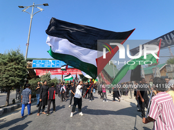 Kashmiri Shia Muslims are displaying Palestinian flags during a procession on the 8th of Muharram in Srinagar, Indian Administered Kashmir,...