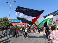 Kashmiri Shia Muslims are displaying Palestinian flags during a procession on the 8th of Muharram in Srinagar, Indian Administered Kashmir,...