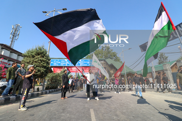 Kashmiri Shia Muslims are displaying Palestinian flags during a procession on the 8th of Muharram in Srinagar, Indian Administered Kashmir,...