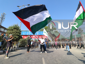 Kashmiri Shia Muslims are displaying Palestinian flags during a procession on the 8th of Muharram in Srinagar, Indian Administered Kashmir,...