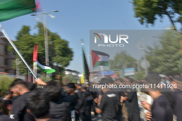 Kashmiri Shia Muslims are displaying Palestinian flags during a procession on the 8th of Muharram in Srinagar, Indian Administered Kashmir,...