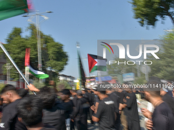 Kashmiri Shia Muslims are displaying Palestinian flags during a procession on the 8th of Muharram in Srinagar, Indian Administered Kashmir,...