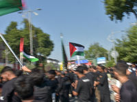 Kashmiri Shia Muslims are displaying Palestinian flags during a procession on the 8th of Muharram in Srinagar, Indian Administered Kashmir,...