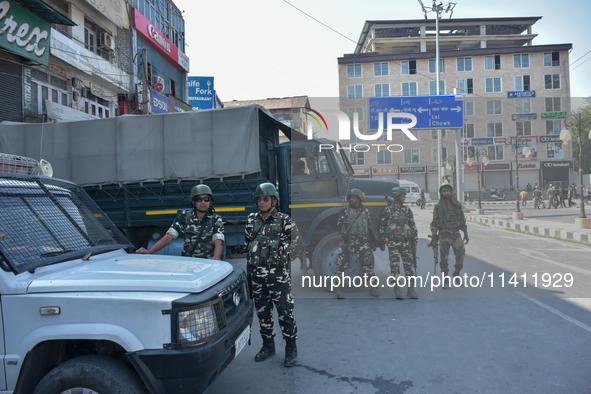 Indian paramilitary troopers are standing alert during a procession on the 8th of Muharram in Srinagar, Indian Administered Kashmir, on July...