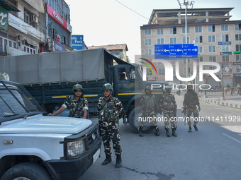 Indian paramilitary troopers are standing alert during a procession on the 8th of Muharram in Srinagar, Indian Administered Kashmir, on July...