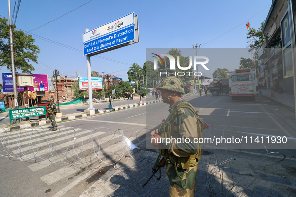 Indian paramilitary troopers are standing alert during a procession on the 8th of Muharram in Srinagar, Indian Administered Kashmir, on July...