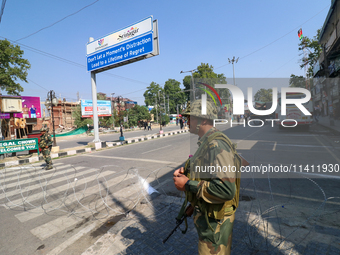 Indian paramilitary troopers are standing alert during a procession on the 8th of Muharram in Srinagar, Indian Administered Kashmir, on July...