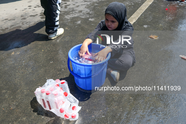 A Kashmiri Shia Muslim girl is offering water during a Muharram procession in Srinagar, Indian Administered Kashmir, on July 15, 2024. 