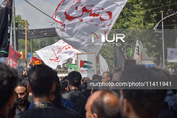 Kashmiri Shia Muslims are displaying flags during a procession on the 8th of Muharram in Srinagar, Indian Administered Kashmir, on July 15,...