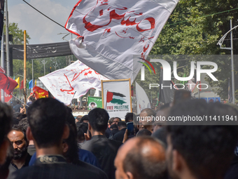 Kashmiri Shia Muslims are displaying flags during a procession on the 8th of Muharram in Srinagar, Indian Administered Kashmir, on July 15,...