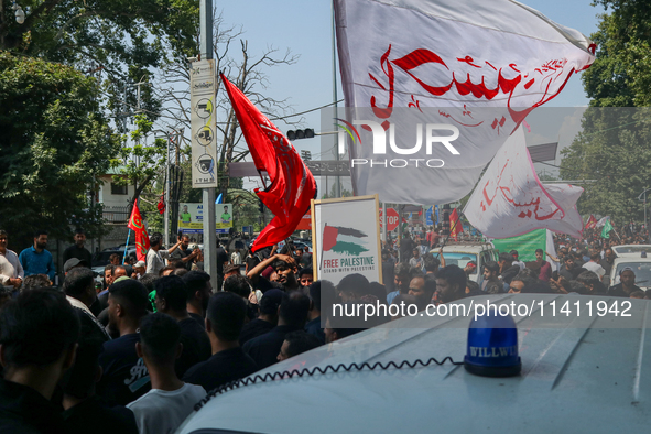 Kashmiri Shia Muslims are displaying flags during a procession on the 8th of Muharram in Srinagar, Indian Administered Kashmir, on July 15,...