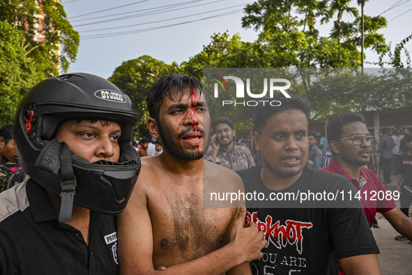 A student is being injured during a clash between anti-quota protesters and students backing the ruling Awami League party on Dhaka Universi...