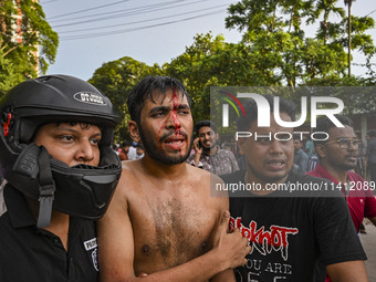 A student is being injured during a clash between anti-quota protesters and students backing the ruling Awami League party on Dhaka Universi...