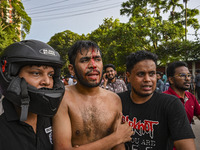 A student is being injured during a clash between anti-quota protesters and students backing the ruling Awami League party on Dhaka Universi...