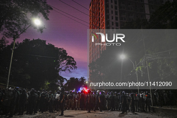 Bangladesh riot police are taking a position in front of Shahidullah Hall during clashes between anti-quota protesters and students backing...