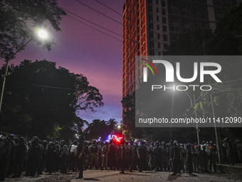 Bangladesh riot police are taking a position in front of Shahidullah Hall during clashes between anti-quota protesters and students backing...