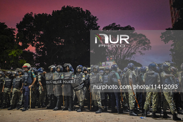 Bangladesh riot police are taking a position in front of Shahidullah Hall during clashes between anti-quota protesters and students backing...