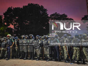 Bangladesh riot police are taking a position in front of Shahidullah Hall during clashes between anti-quota protesters and students backing...