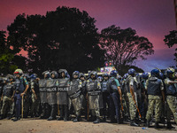 Bangladesh riot police are taking a position in front of Shahidullah Hall during clashes between anti-quota protesters and students backing...