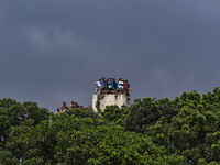 Students are standing on the roof to see the clash between BCL members (Ruling Party Members) and student protesters, during anti-quota prot...