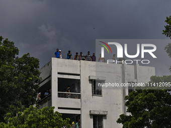 Students are standing on the roof to see the clash between BCL members (Ruling Party Members) and student protesters, during anti-quota prot...