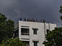 Students are standing on the roof to see the clash between BCL members (Ruling Party Members) and student protesters, during anti-quota prot...