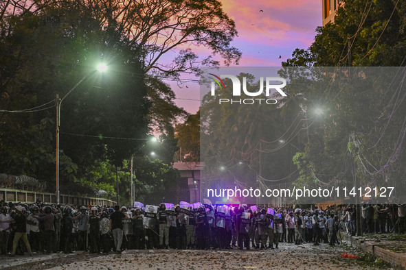 Bangladesh riot police are taking a position in front of Shahidullah Hall during clashes between anti-quota protesters and students backing...