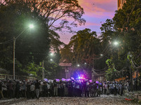 Bangladesh riot police are taking a position in front of Shahidullah Hall during clashes between anti-quota protesters and students backing...